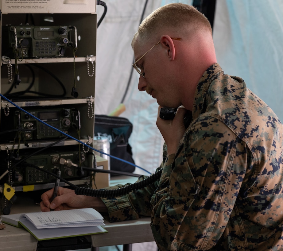 U.S. Marine Corps Sgt. Chadwick Lewis, a ground electronics transmissions maintainer with Detachment, Communications Company, 14th Marine Regiment, 4th Marine Division, copies down a 9-line inside a combat operations center during a joint communications exercise with the 38th Combat Aviation Brigade, Indiana National Guard, at Camp Atterbury in Edinburgh, Indiana, on March 14, 2025.



The joint communications exercise tested the Marines’ ability to rapidly deploy and establish secure communications in an operational environment. Upon insertion via UH-60 Black Hawk helicopters, radio teams established encrypted high-frequency networks with the combat operations center, coordinated simulated medical evacuations, and executed air extractions, demonstrating their capability to maneuver and communicate in dynamic conditions alongside joint force partners.



(U.S. Marine Corps Photo by Maj. Lara Soto)