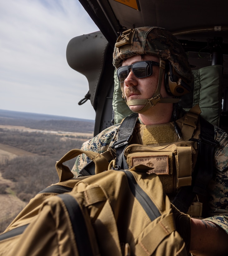 U.S. Marine Corps Sgt. Kyle Dykins, a transmissions system operator with Detachment, Communication Company, 14th Marine Regiment, 4th Marine Division, scans the training area after an extraction via a UH-60 Black Hawk during a joint communications exercise with the 38th Combat Aviation Brigade, Indiana National Guard in Camp Atterbury, Edinburgh, Indiana, March 14, 2025.