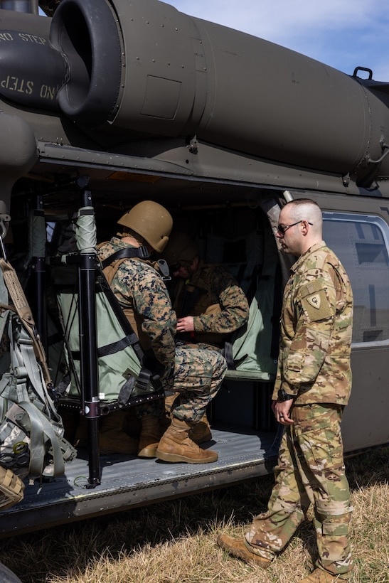 Indiana Army National Guard Staff Sgt. Josh Castaneda instructs Marines on landing zone preparation and procedures during a flight safety briefing for a joint communications exercise with the 38th Combat Aviation Brigade, Indiana National Guard, at Camp Atterbury in Edinburgh, Indiana, on March 14, 2025.