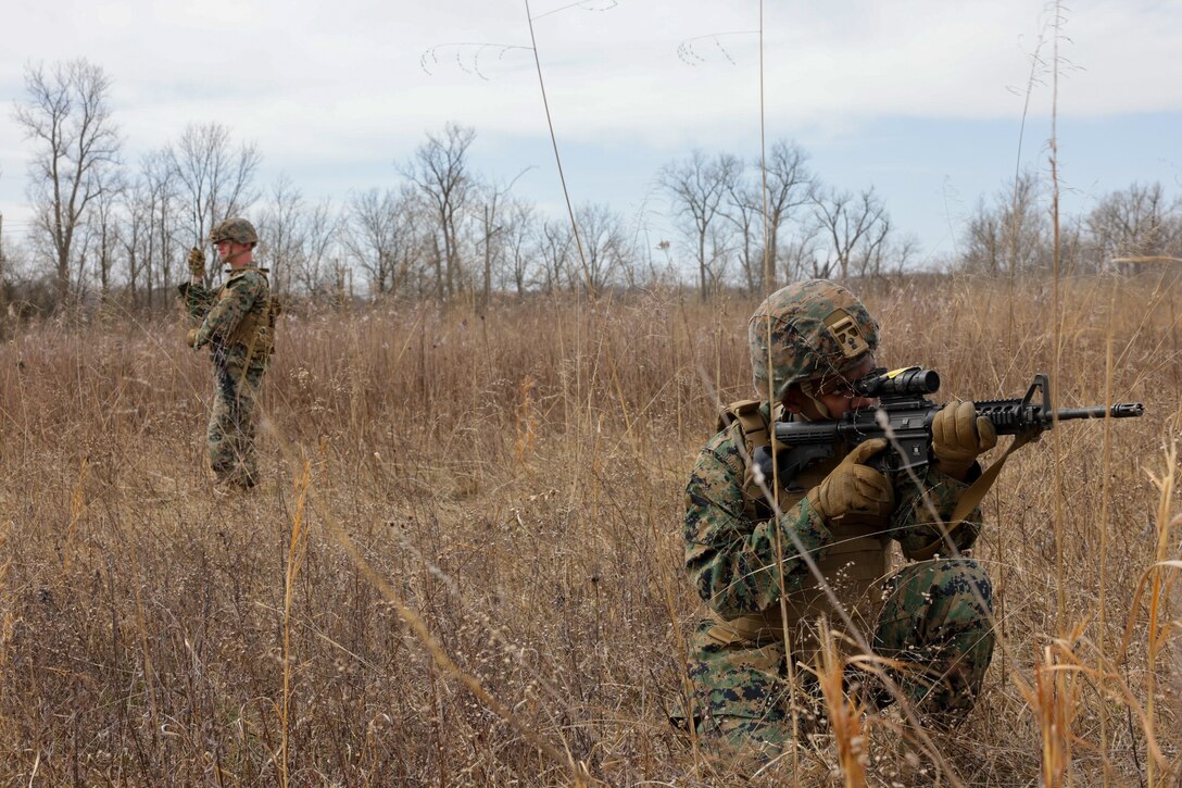 U.S. Marine Corps Lance Cpl. Sizwile Nyoni, a satellite communications operator with Detachment, Communication Company, 14th Marine Regiment, 4th Marine Division, provides security while Marines set up a field expedient high frequency (HF) antenna during a joint communications exercise with the 38th Combat Aviation Brigade, Indiana National Guard in Camp Atterbury, Edinburgh, Indiana, March 14, 2025.