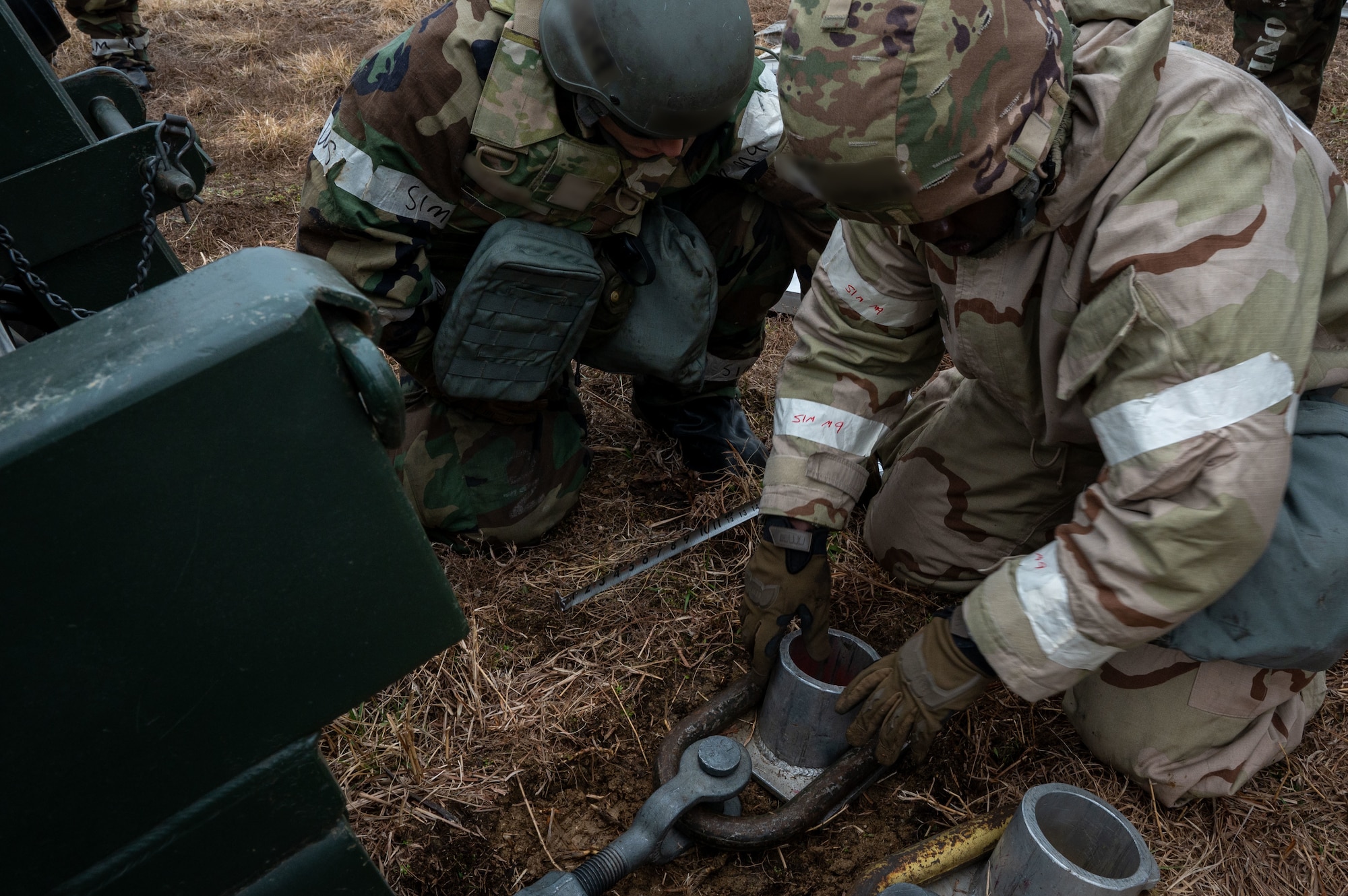 U.S. Airmen assigned to the 11th Air Task Force and 51st Fighter Wing secure the base of an aircraft arresting system at Osan Air Base, South Korea, March 12, 2025. During Freedom Shield 25, personnel from the 11th ATF and 51st FW worked together to deploy an aircraft arresting system, a machine designed to safely stop aircraft during emergencies. (U.S. Air Force photo by Senior Airman Jasmyne Bridgers-Matos)