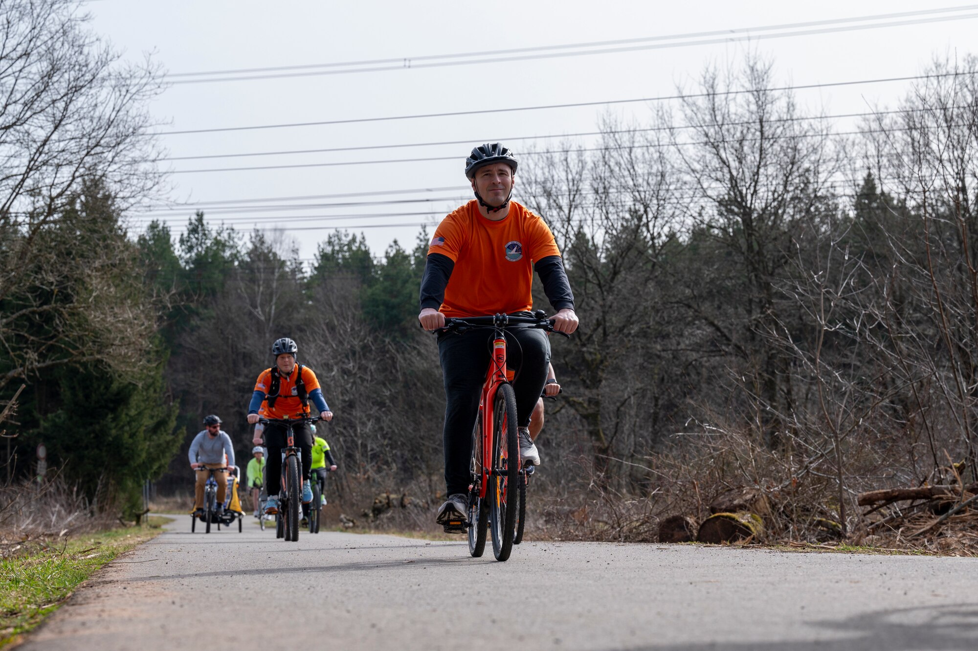 Participants of Grant’s Ride, an annual memorial ride in honor of U.S. Air Force Staff Sgt. Grant Davis, a member of the 76th Airlift Squadron who passed away in a cycling accident, bike together to a roadside memorial near Ramstein Air Base, Germany, March 21, 2025.