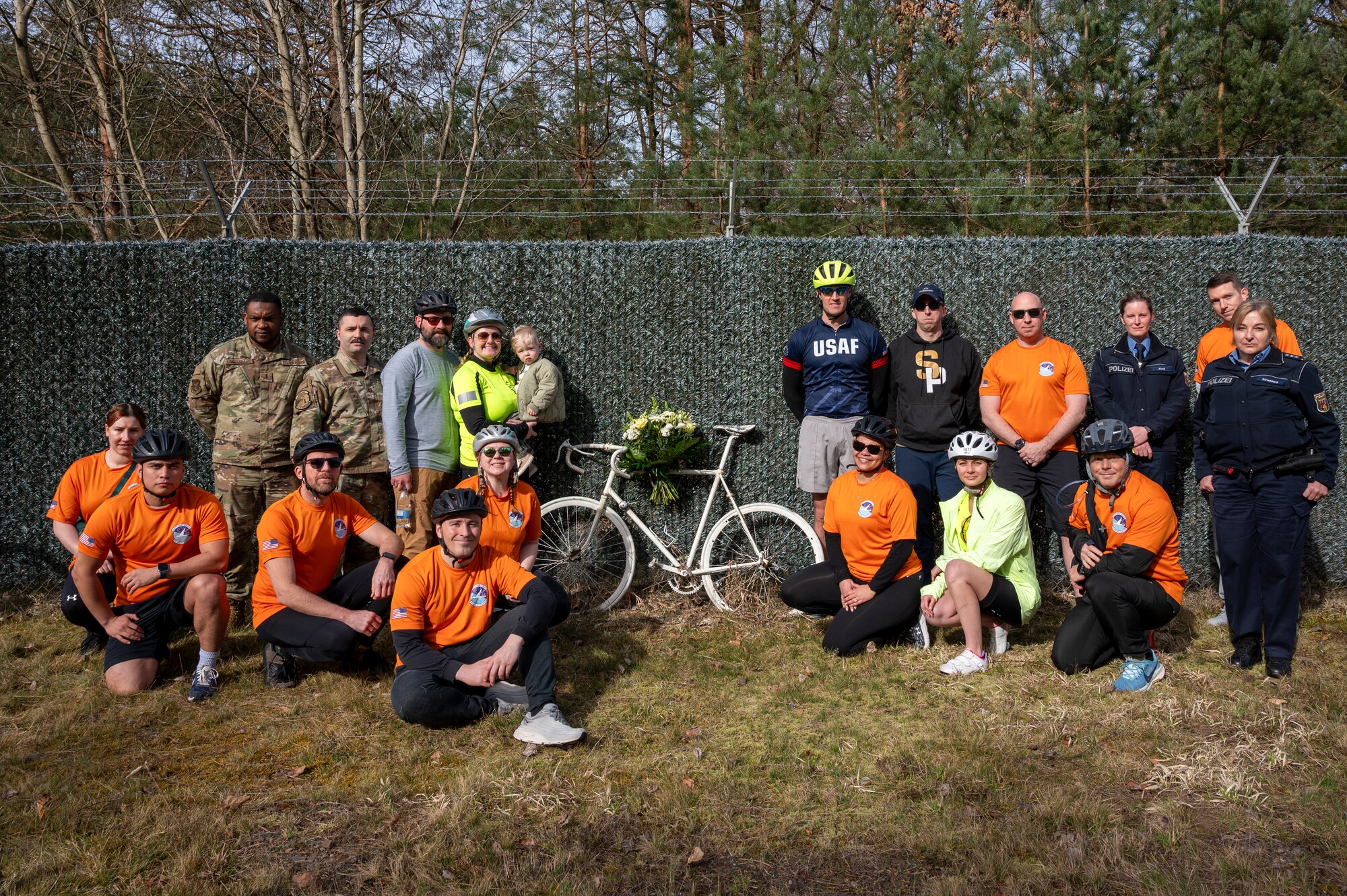 U.S. Air Force chaplains, 76th Airlift Squadron members and German Polizei members pose for a group photo at Staff Sgt. Grant Davis’ roadside memorial near Ramstein Air Base, Germany, March 21, 2025.