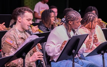 Sgt. Demitri Funnell, from the Illinois Army National Guard’s 144th Army Band, along students with the Walter H. Dyett High School for Fine Arts in Chicago, play a musical selection during the third annual Captain Walter H. Dyett award ceremony March 19.