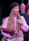 Aaliyah Johnson, the 2025 recipient of the Capt. Walter Dyett award, thanks the 8th Infantry Association for presenting her with the award during the third annual Captain Walter H. Dyett award ceremony at Walter H. Dyett High School for the Fine Arts March 19 in Chicago.