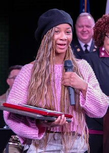 Aaliyah Johnson, the 2025 recipient of the Capt. Walter Dyett award, thanks the 8th Infantry Association for presenting her with the award during the third annual Captain Walter H. Dyett award ceremony at Walter H. Dyett High School for the Fine Arts March 19 in Chicago.