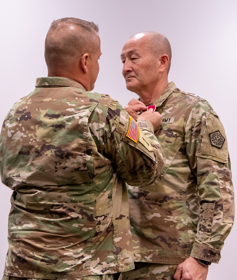 Col. Eric Smith, of Springfield, is presented the Legion of Merit by Maj. Gen. (ret.) Eric Little, in honor of Smith’s 36 years of military service during a retirement ceremony March 21 at the Illinois Military Academy on Camp Lincoln, Springfield.