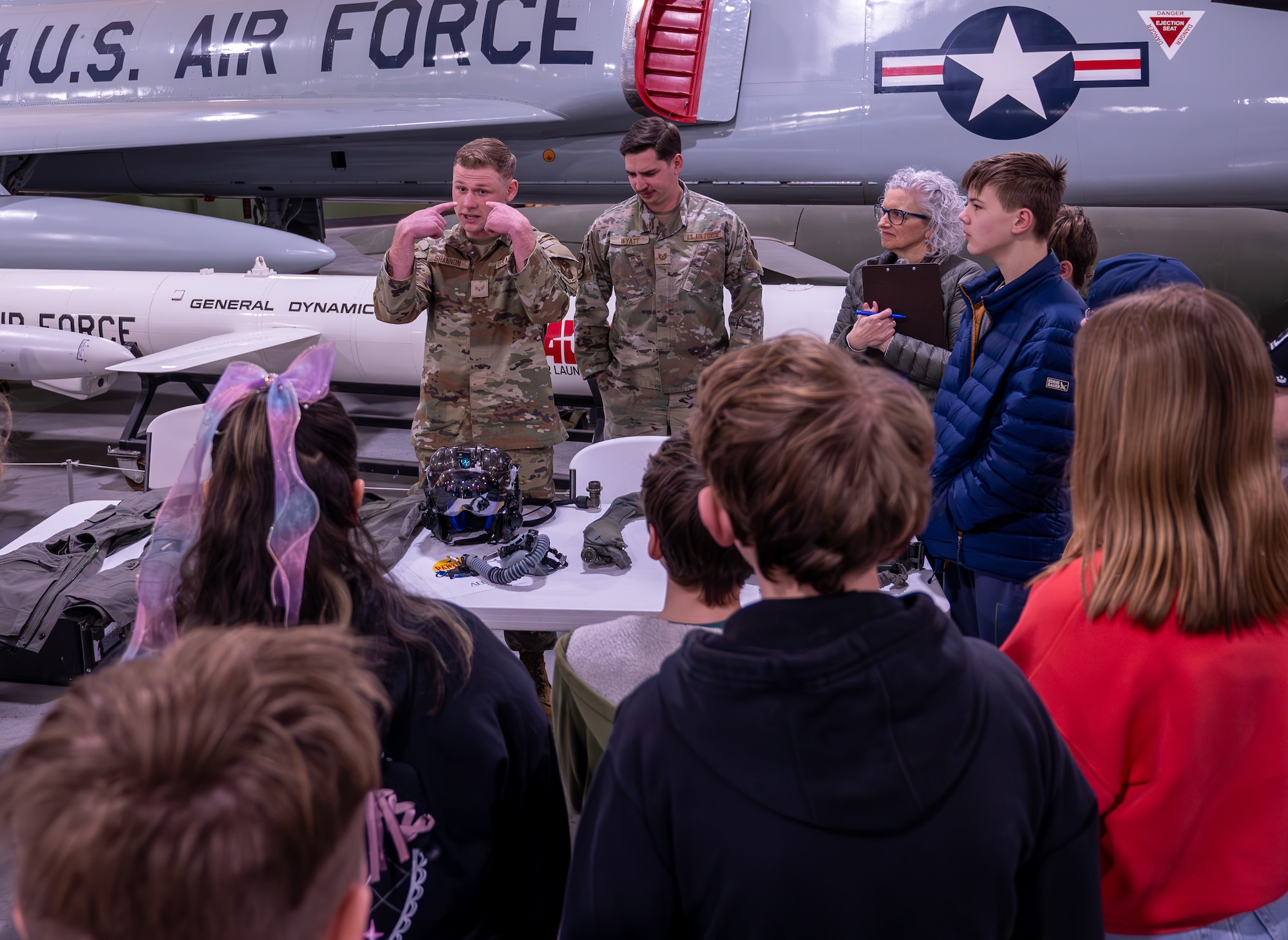 A photo of students interacting with Airmen