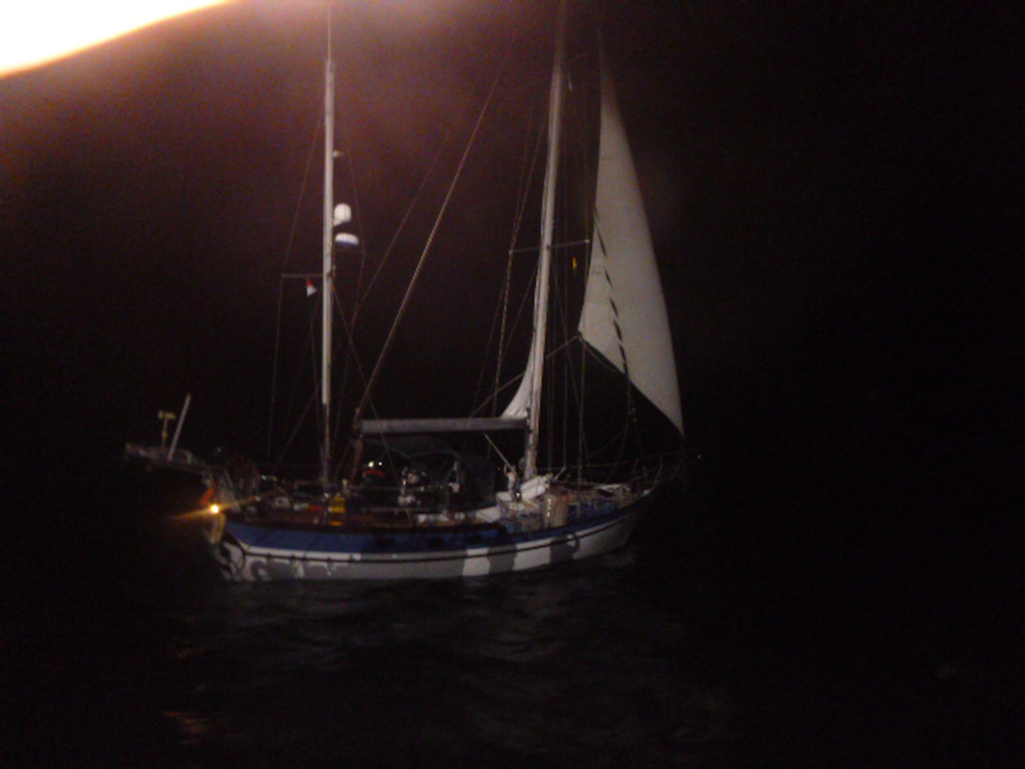 The crew of Coast Guard Cutter Mohawk (WMEC 913) identifies a sailing vessel suspected of drug smuggling while underway in the Eastern Pacific Ocean, Feb. 19, 2025. During a law enforcement boarding, the crew discovered approximately 637 pounds of cocaine hidden onboard. (U.S. Coast Guard photo, courtesy Cutter Mohawk)