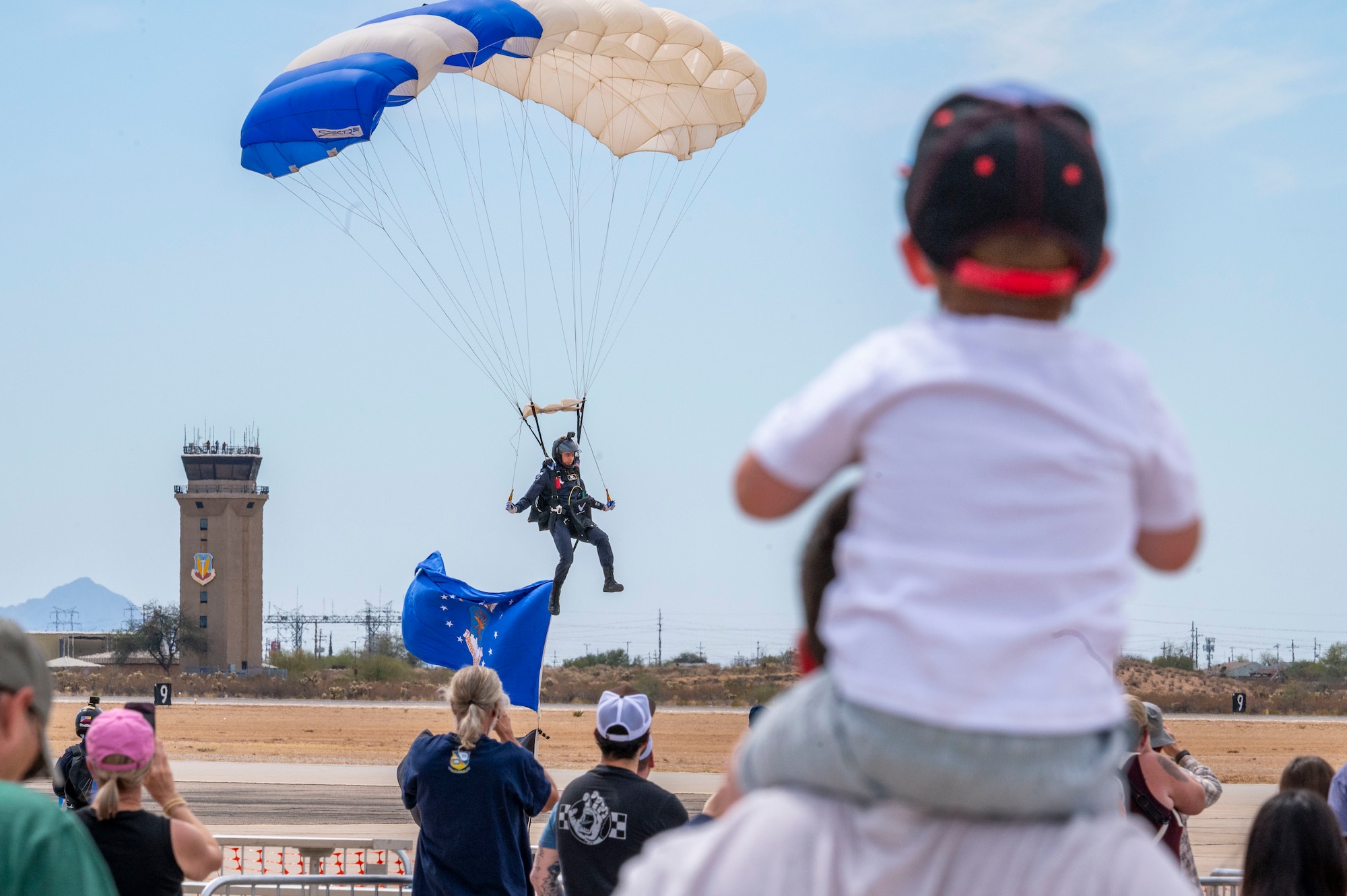 A U.S. Air Force Academy cadet, Wings of Blue Parachute Team member, lands on the flightline during the 2025 Thunder and Lightning Over Arizona Air Show at Davis-Monthan Air Force Base, Arizona, March 23, 2025. The Wings of Blue is renowned for their precision skydiving and aerial demonstrations. (U.S. Air Force photo by Airman Samantha Melecio)