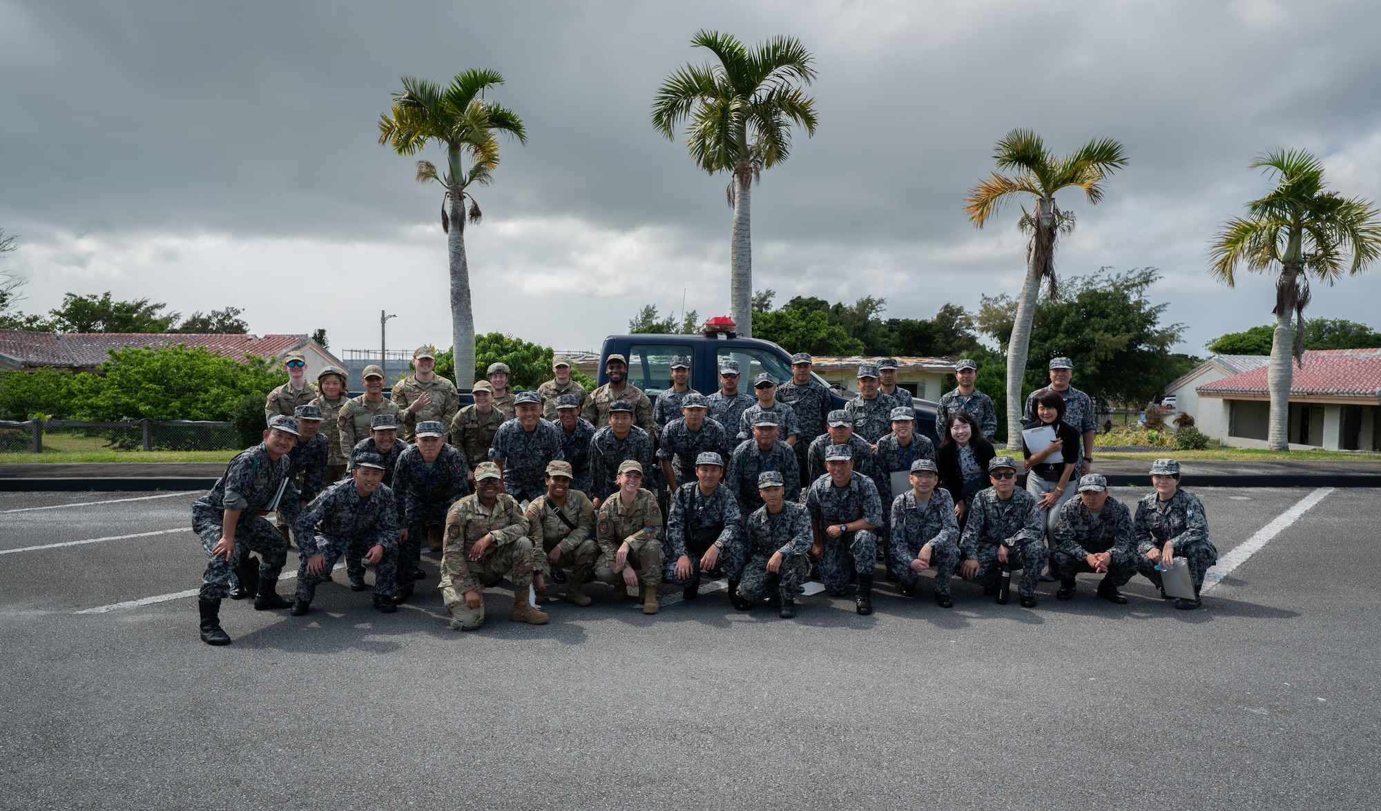 U.S. service members and Japanese Air Self-Defense members pose for a photo.