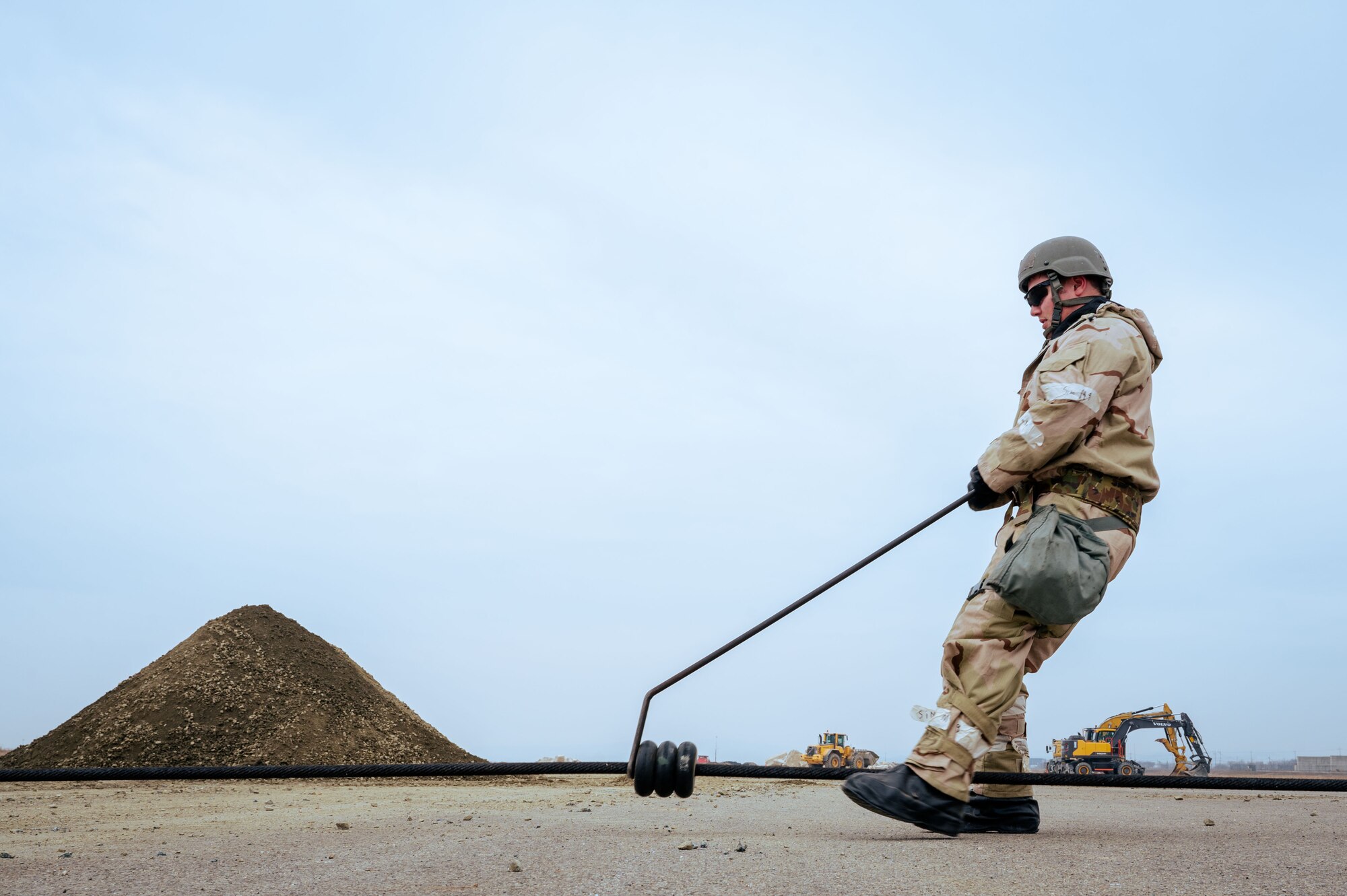 A U.S. Airman assigned to the 11th Air Task Force sets up the steel wire rope of an aircraft arresting system at Osan Air Base, South Korea, March 12, 2025. During Freedom Shield 25, Airmen from the 11th ATF Airmen trained alongside the 51st Fighter Wing personnel to become certified on AAS tasks and procedures. (U.S. Air Force photo by Senior Airman Jasmyne Bridgers-Matos)