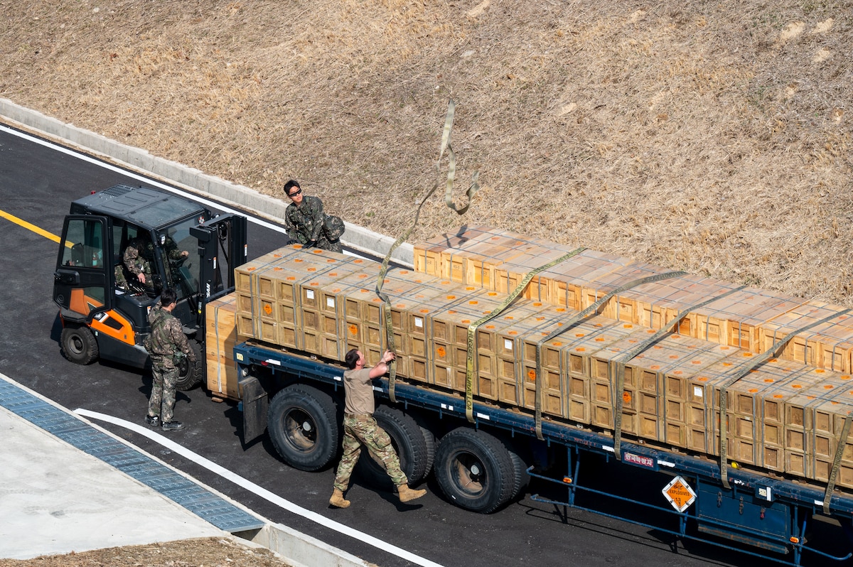 U.S. 11th Air Task Force Airmen and members of the Republic of Korea Air Force secure munitions onto a vehicle in support of Freedom Shield 25 at Suwon Air Base, South Korea, March 11, 2025. 11 ATF Airmen assisted ROKAF service members with the movement of munitions in order to guarantee safe handling, efficient organization and quick accessibility for potential operations. (U.S. Air Force photo by Senior Airman Jasmyne Bridgers-Matos)