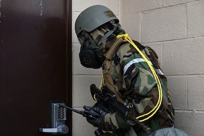 U.S. Air Force Staff Sgt. Richard Lloyd, 8th Communications Squadron expeditionary communications NCO in charge, facility entry sign procedures after conducting a post-attack reconnaissance sweep during Freedom Shield 25 at Gwangju Air Base, Republic of Korea.