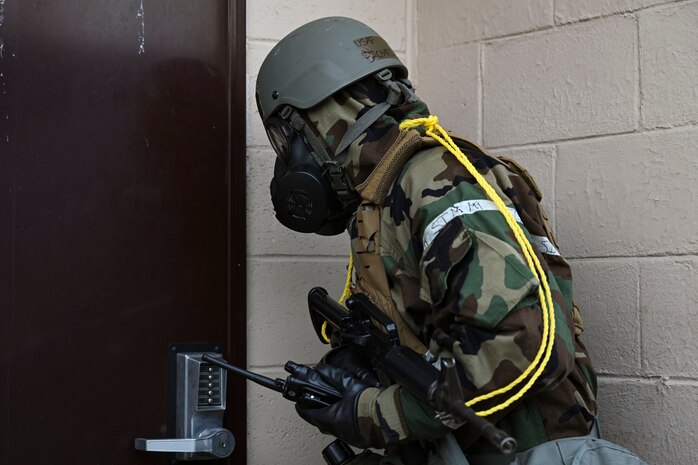 U.S. Air Force Staff Sgt. Richard Lloyd, 8th Communications Squadron expeditionary communications NCO in charge, facility entry sign procedures after conducting a post-attack reconnaissance sweep during Freedom Shield 25 at Gwangju Air Base, Republic of Korea.