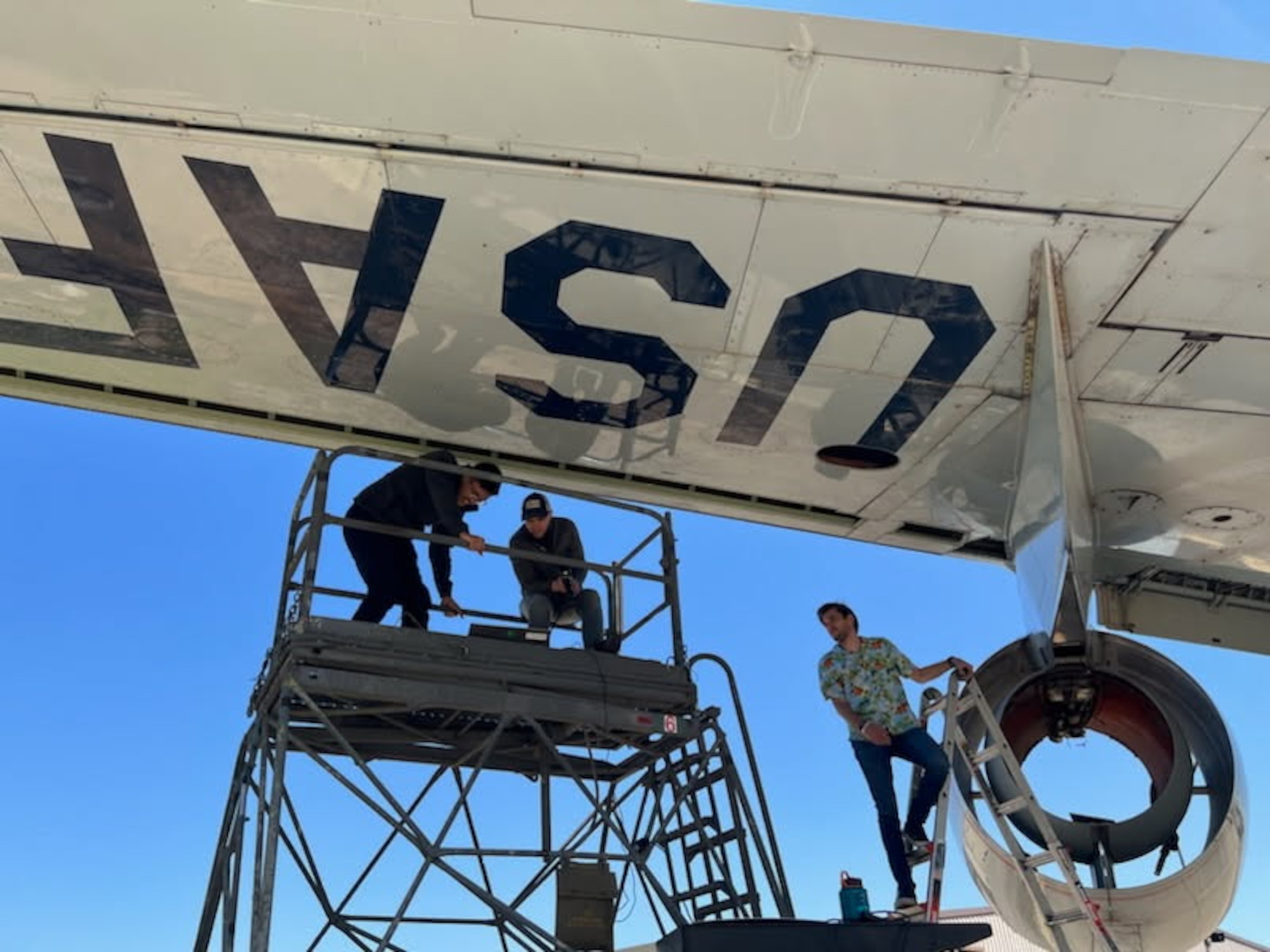 Three men working on a KC-135.