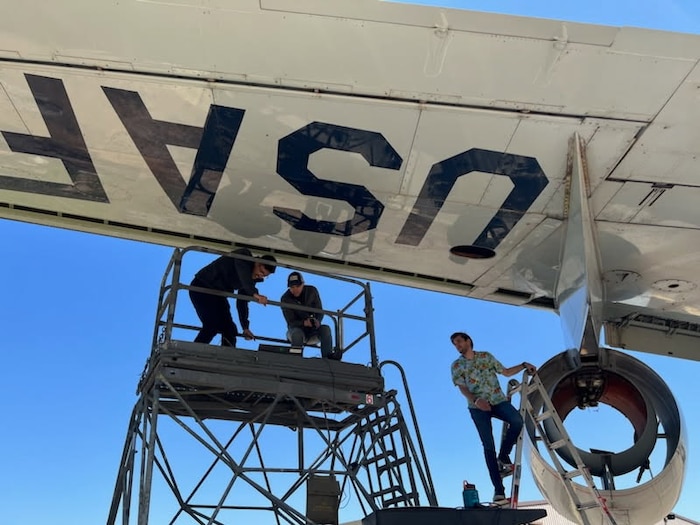 Three men working on a KC-135.