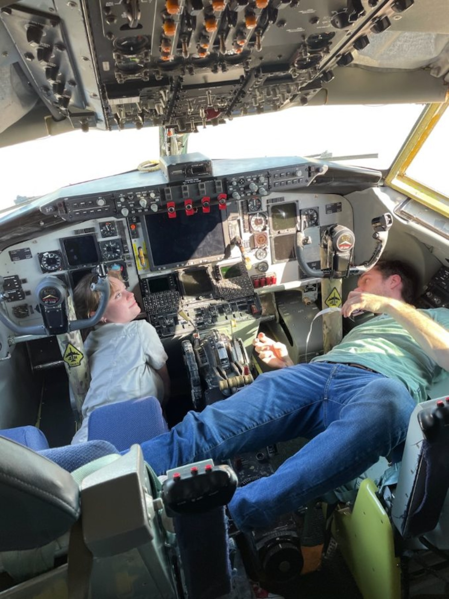 Two engineers working in a KC-135 cockpit.