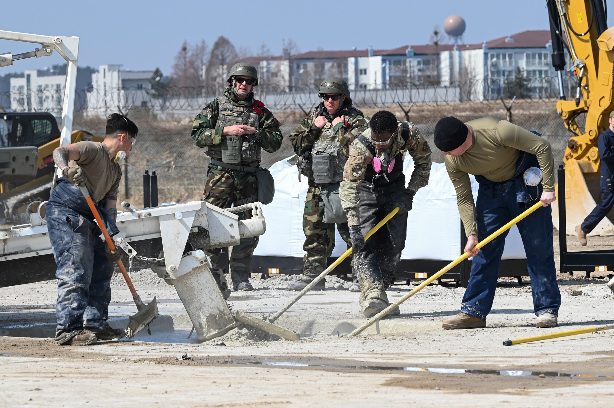 Members of the 8th Fighter Wing inspection team oversee Airmen assigned to the 8th Civil Engineer Squadron smooth out layers of concrete in a Rapid Airfield Damage Recovery after a simulated attack during Freedom Shield 25 at Kunsan Air Base, Republic of Korea.