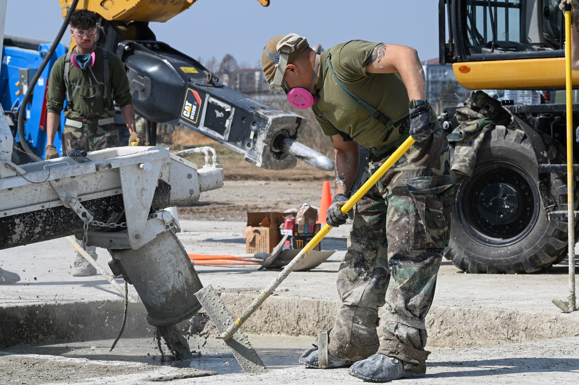 U.S. Marine Corps Sgt. Kevin Delgado, a combat engineer with Marine Wing Support Squadron 172, Marine Aircraft Group 36, 1st Marine Aircraft Wing, smooths out layers of concrete for a Rapid Airfield Damage Recovery with available resources after a simulated attack during Freedom Shield 25 at Kunsan Air Base, Republic of Korea.