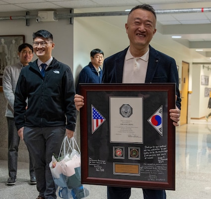 Chi Sang Chong, a facilities specialist for MARFORK, gives remarks after receiving a plaque during a ceremony to commemorate his longstanding service at U.S. Army Garrison Humphreys, South Korea, March 5, 2025. Twenty years ago, Hong Kyun Na and Chong began their work as Korea Garrison Support employees and have been a steady presence at MARFORK since. (U.S. Marine Corps photo by Cpl. Nikolas Mascroft)