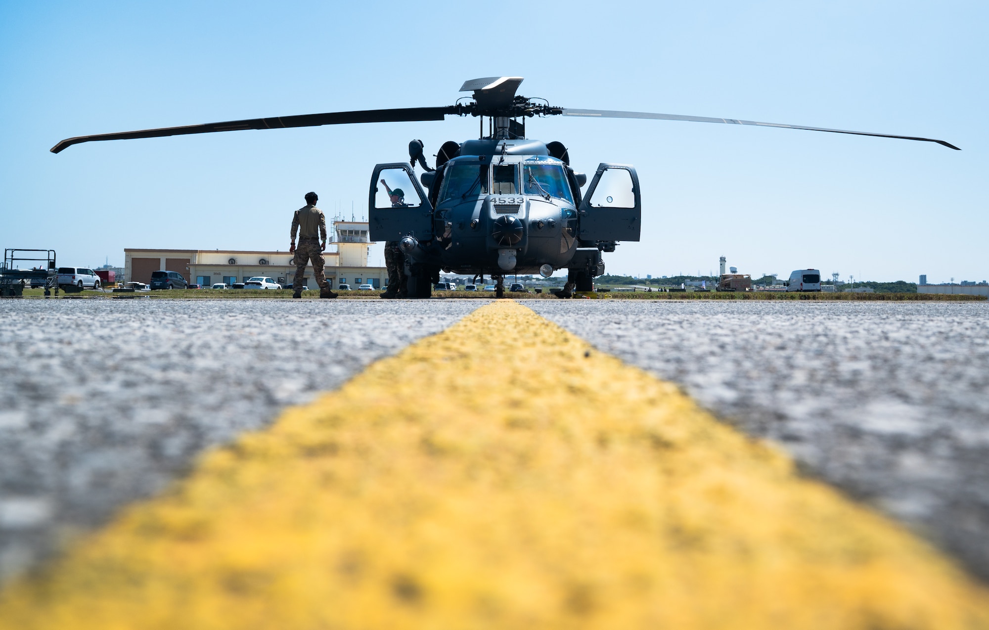 An HH-60W Jolly Green II sits on a flightline.