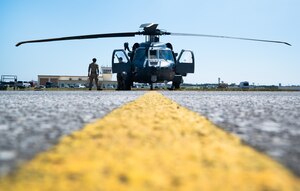 An HH-60W Jolly Green II sits on a flightline.