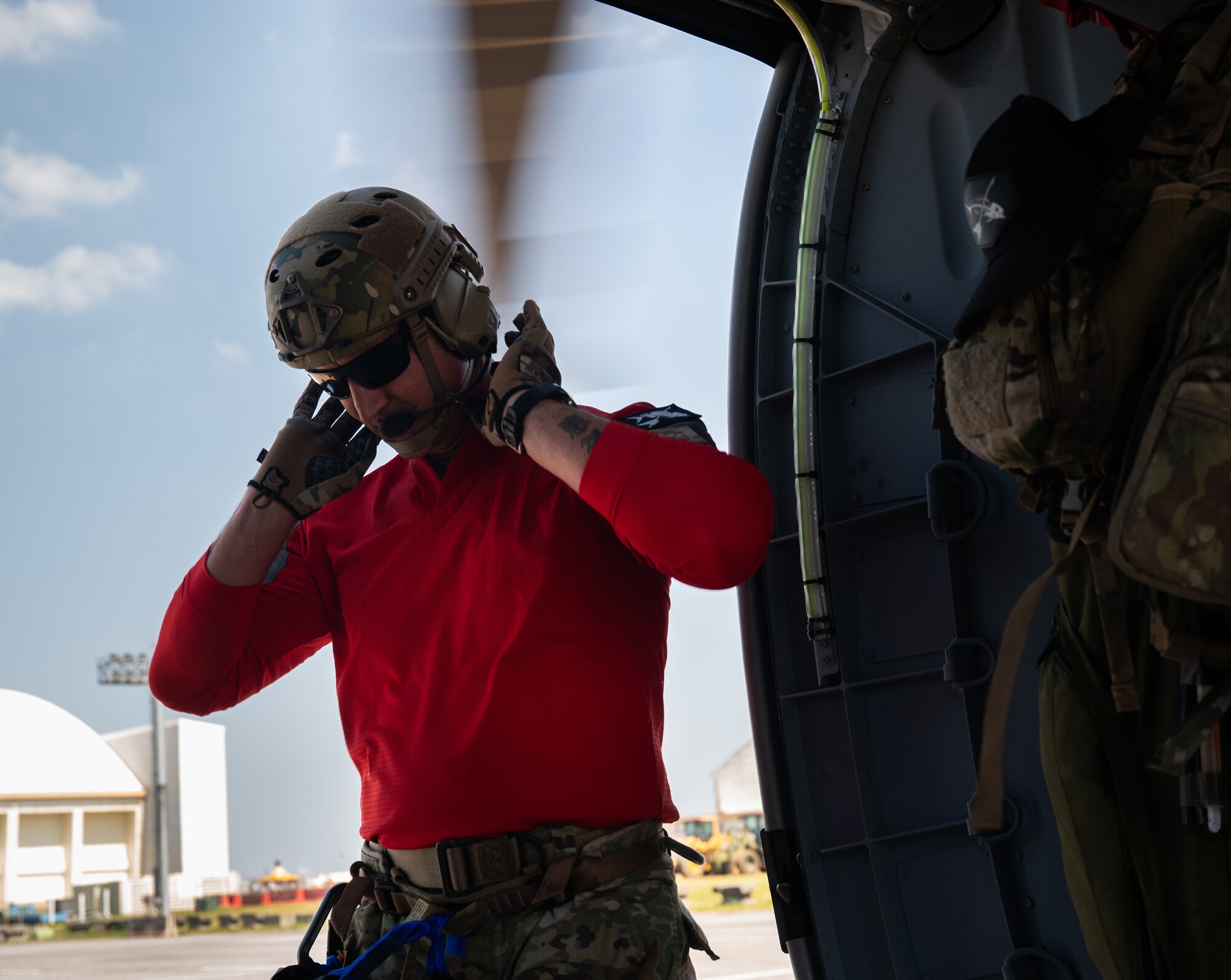 A U.S. service member dons a helmet.