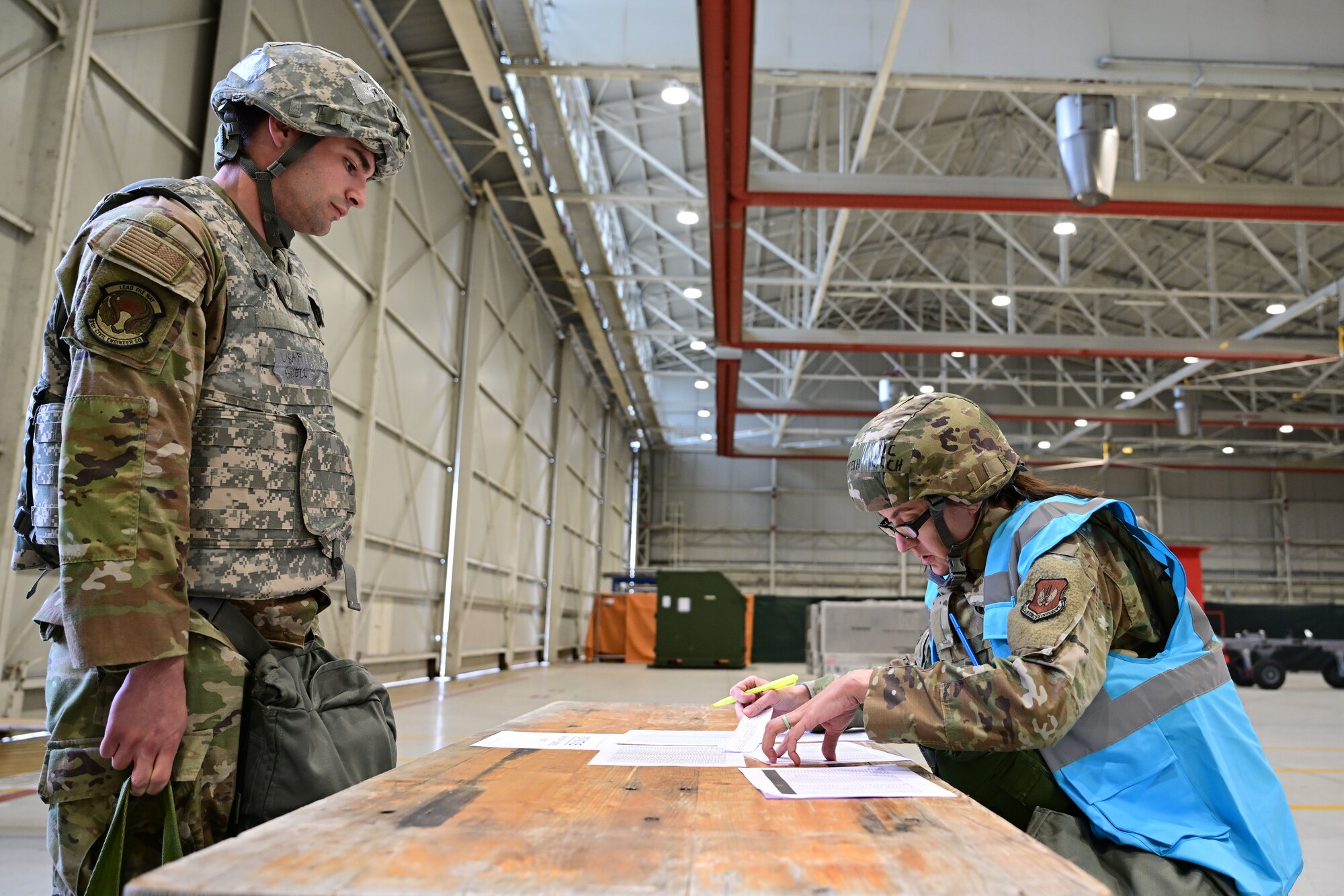Exercise team member checks in mock deployer during exercise.