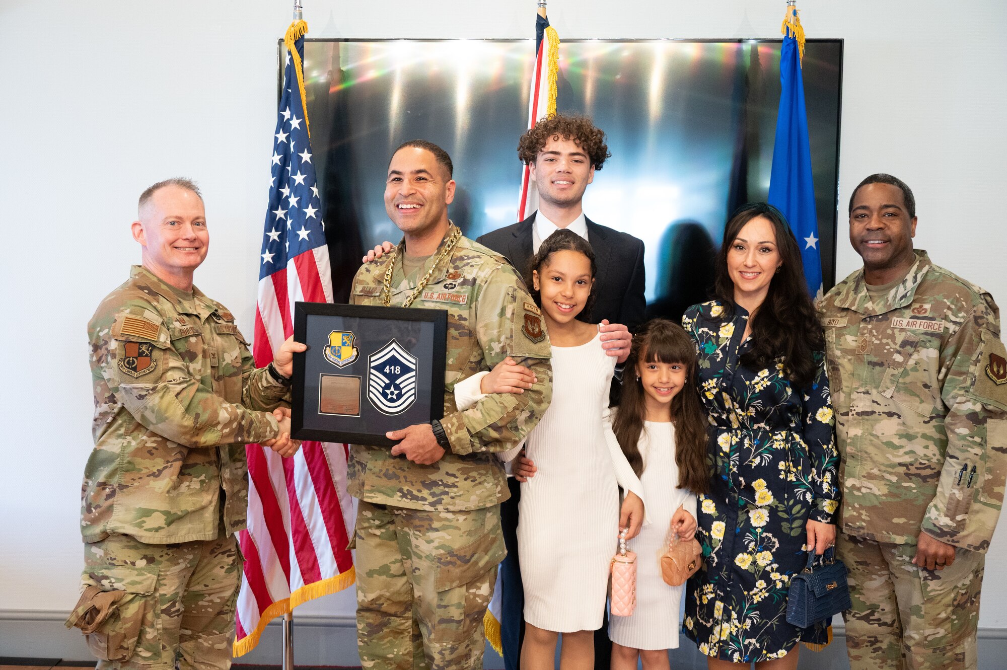 U.S. Air Force Col. D. Landon Phillips, 501st Combat Support Wing (CSW) commander, and Chief Master Sgt. Terrance D. Boyd, 501st CSW command chief, presents a promotion plaque
