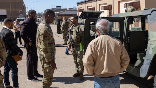 Group of men talking in front of Humvee