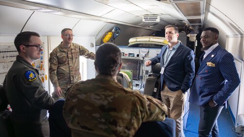 Group of people talking on military aircraft