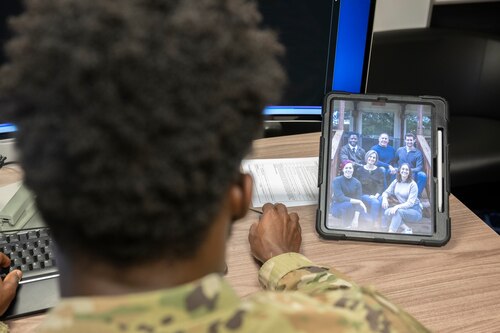 Staff Sgt. Payne looks at a photo of his family on his desk.