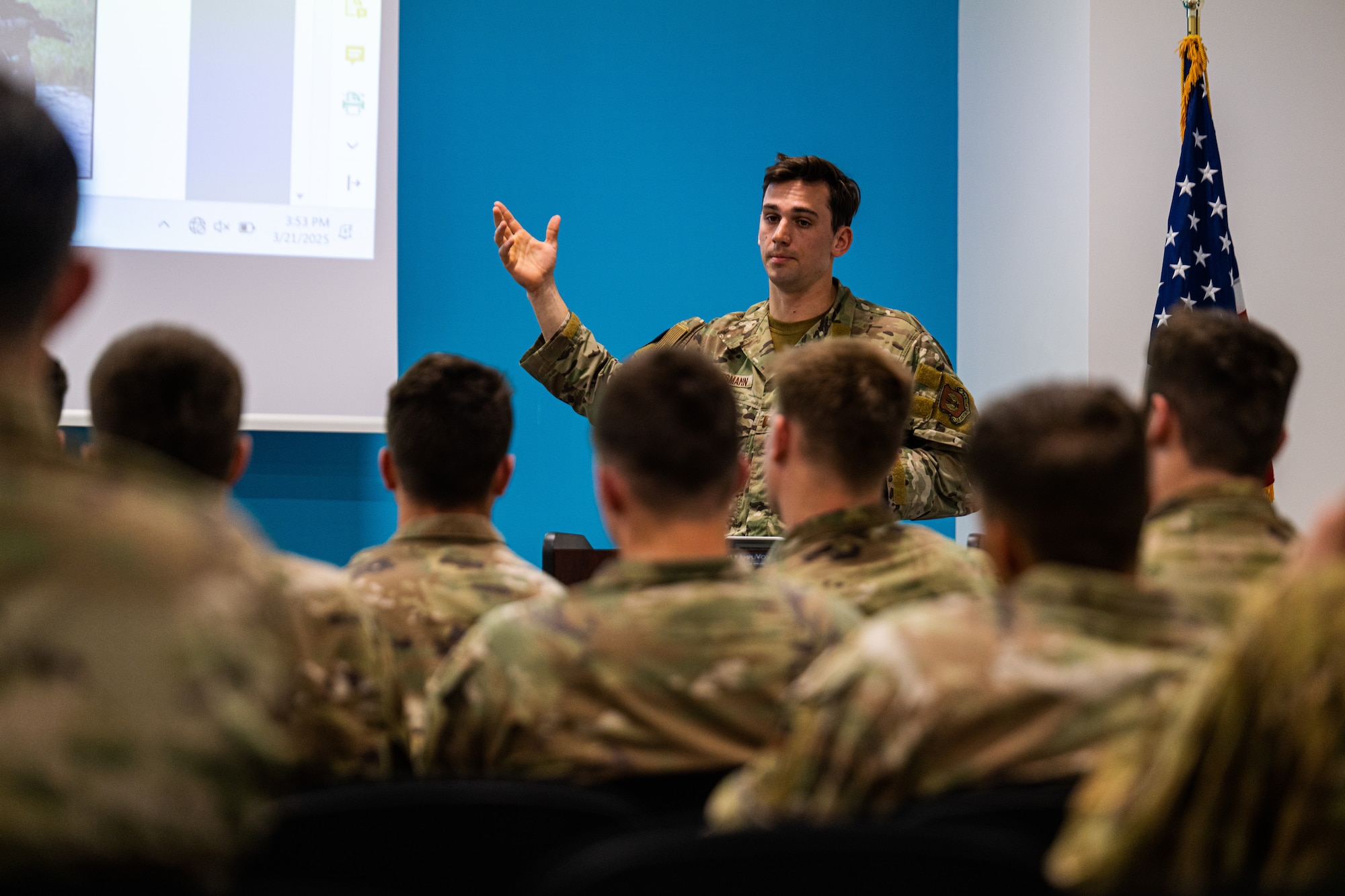 U.S. Air Force Capt. Kyle Bundesmann, 57th Rescue Squadron combat rescue officer, briefs the United States Air Force Academy rugby team about the mission of the 57th RQS during a tour at Aviano Air Base, Italy, March 21, 2025.