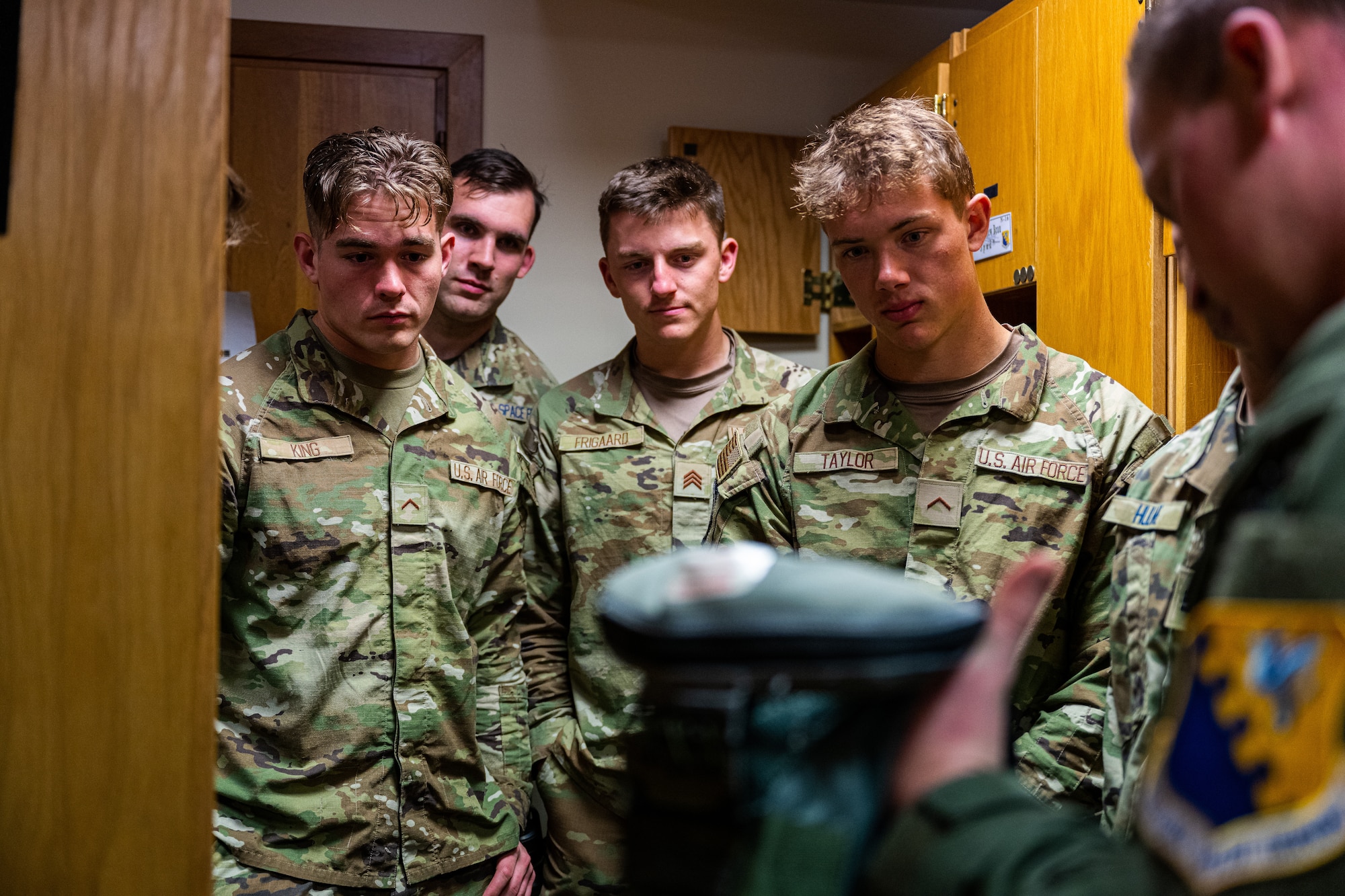 Cadets from the United States Air Force Academy rugby team learn about flight equipment during a tour at Aviano Air Base, Italy, March 21, 2025.