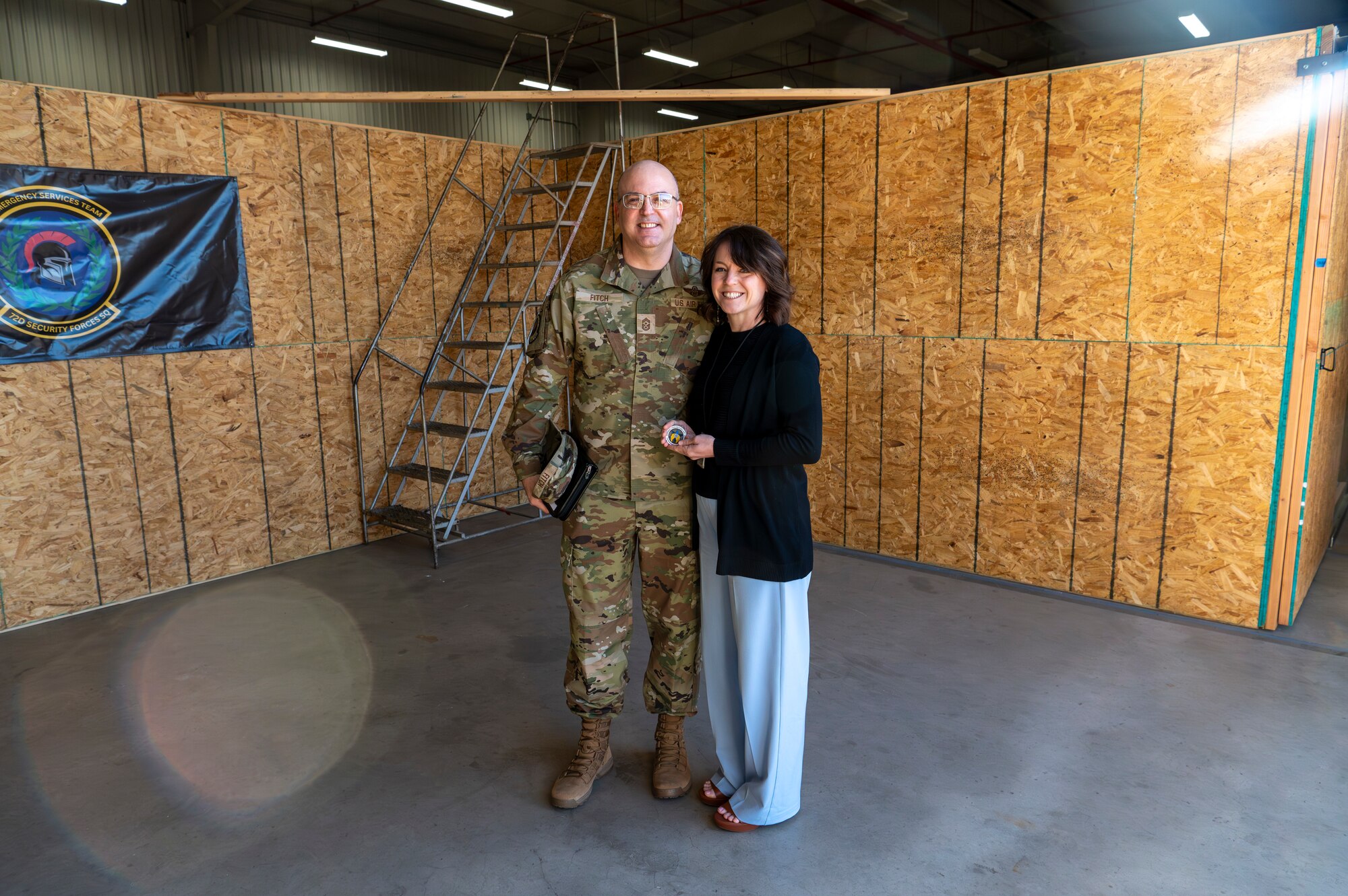Man and woman standing together holding coin