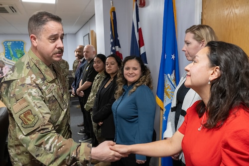Col. Glenn Cameron coins Claudia Evans.