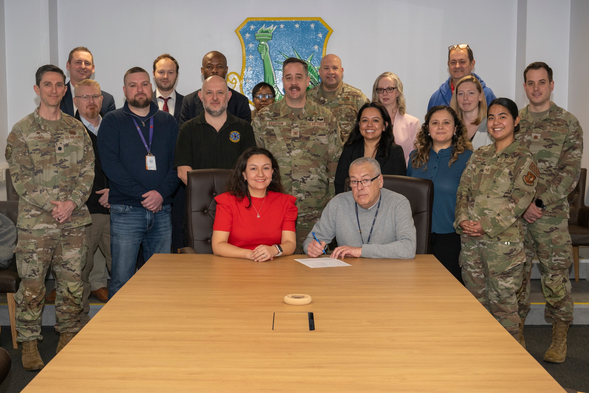 People pose for a photo at the end of a table.