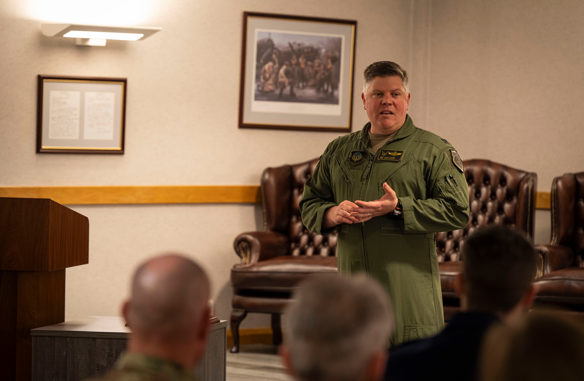 U.S. Air Force Col. Adam Moore, 352nd Special Operations Wing commander, speaks to the attendees of the honorary commanders’ induction ceremony at RAF Mildenhall, England, March 21, 2025.