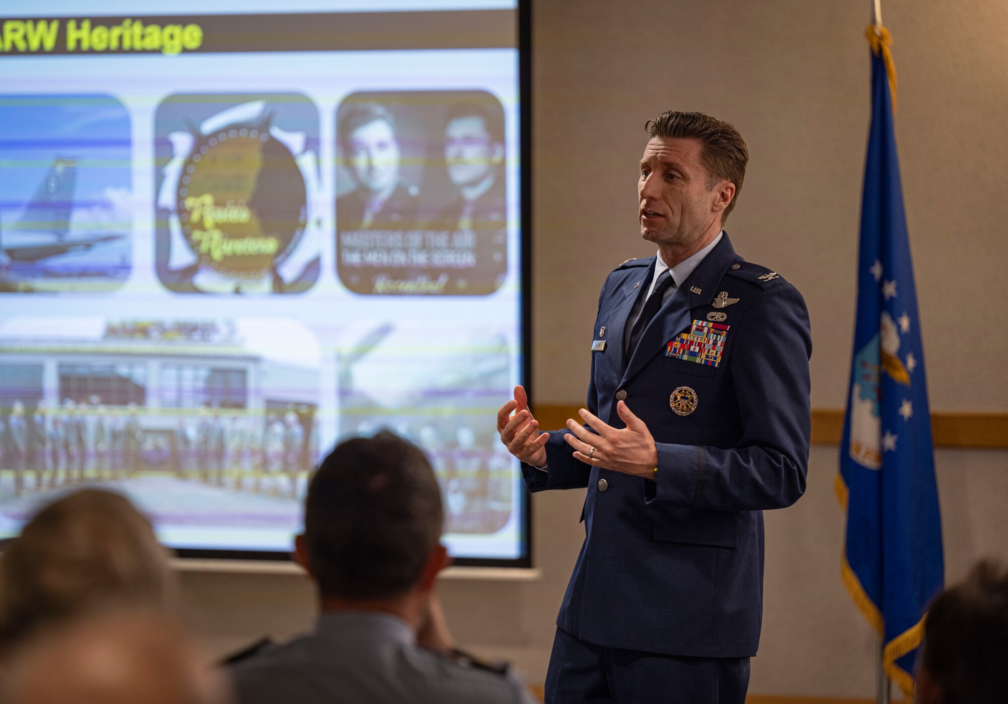 U.S. Air Force Col. Ryan Garlow, 100th Air Refueling Wing commander, speaks on the history and heritage of the 100th ARW during the honorary commanders’ induction ceremony at RAF Mildenhall, England, March 21, 2025.