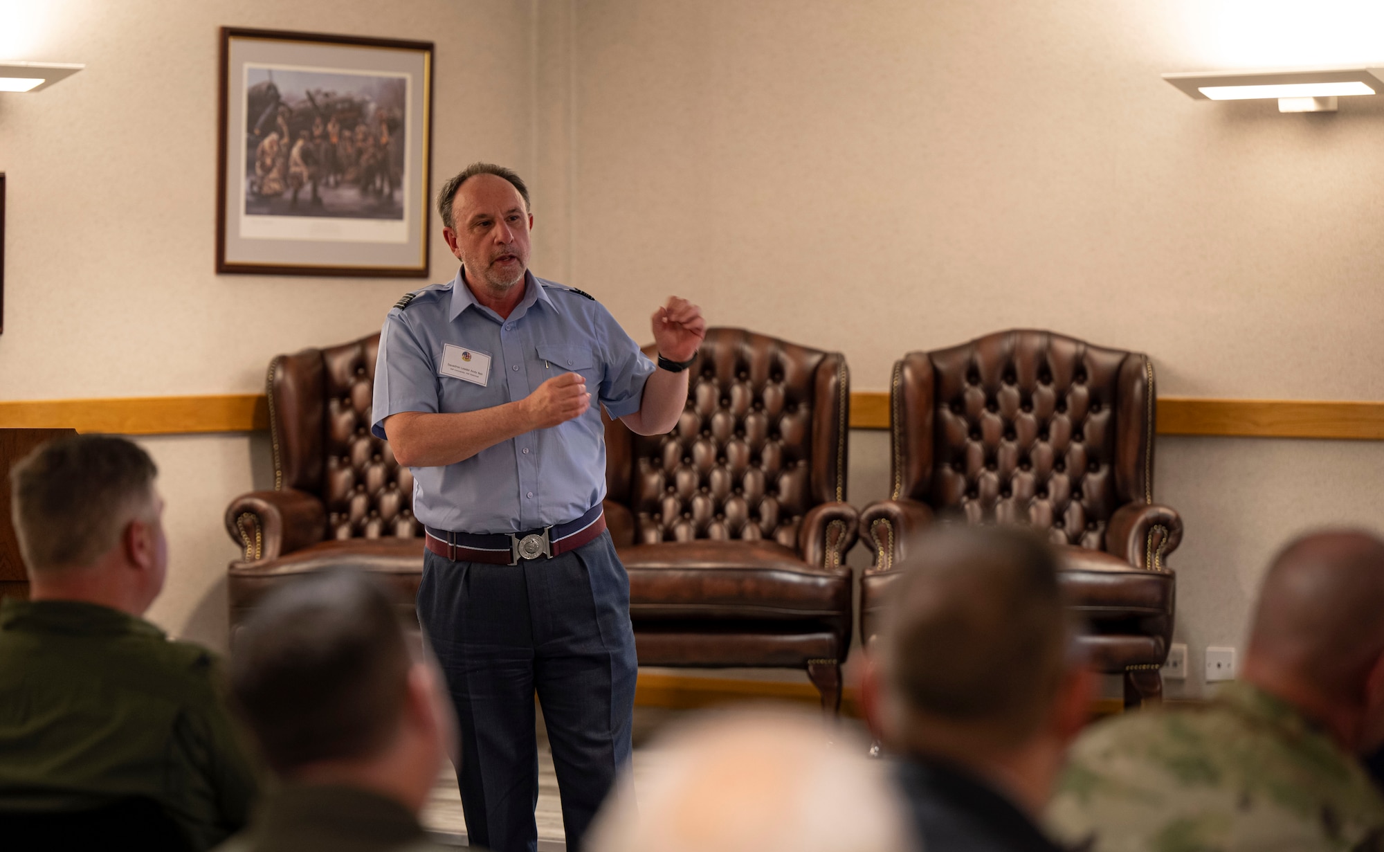 Royal Air Force Sqn Ldr Andy Bell, speaks on the relationship between the RAF and USAF during the honorary commanders’ induction ceremony at RAF Mildenhall, England, March 21, 2025.