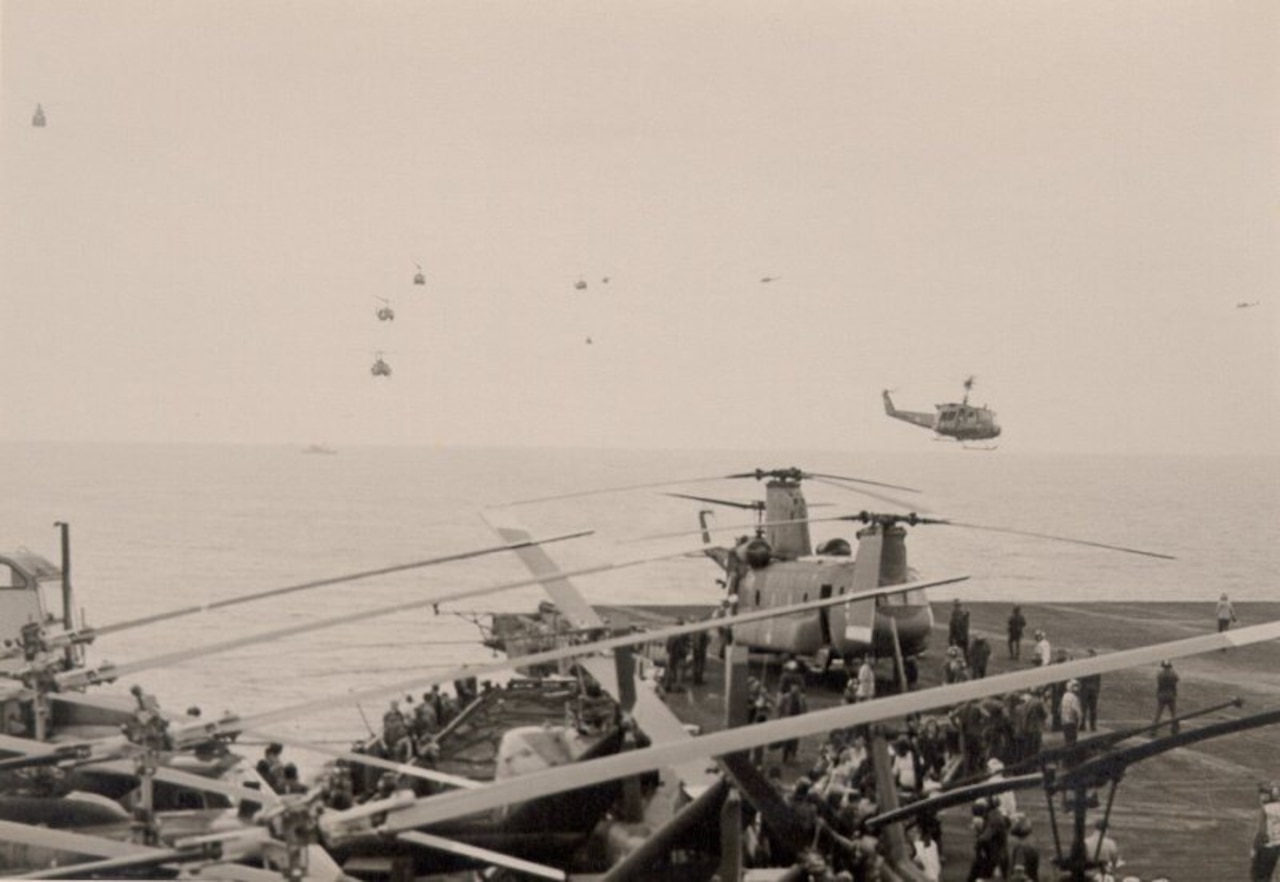 Helicopters land on a ship.