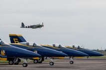 A De Havilland Mosquito passes over U.S. Navy F/A-18 Hornet aircraft of the Blue Angels team at the California Capital Airshow, Mather, California, March 22, 2025.
