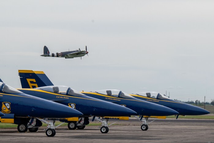 A De Havilland Mosquito passes over U.S. Navy F/A-18 Hornet aircraft of the Blue Angels team at the California Capital Airshow, Mather, California, March 22, 2025.