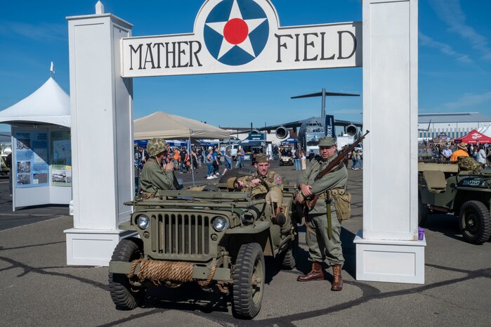 World War II reenactors around a Ford Manufactured GPW “Jeep” at the California Capital Airshow beneath the Mather Field sign at Mather, California, March 23, 2025.