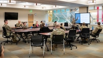 A 5th Medical Group clinical team chief gives a presentation about mass casualty procedures to a room full of Airmen.