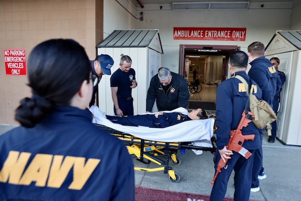 Hospital corpsmen assigned to the Multi-Service Unit at Naval Hospital Twentynine Palms participate in Tactical Combat Casualty Care (TCCC) training alongside the Marine Corps Air Ground Combat Center Fire Department on March 21. The hands-on exercise reinforced critical trauma response skills, ensuring corpsmen are prepared to provide life-saving care in mass casualty and combat scenarios (U.S. Navy photo by Christopher C. Jones, NHTP/NMRTC Twentynine Palms public affairs officer).