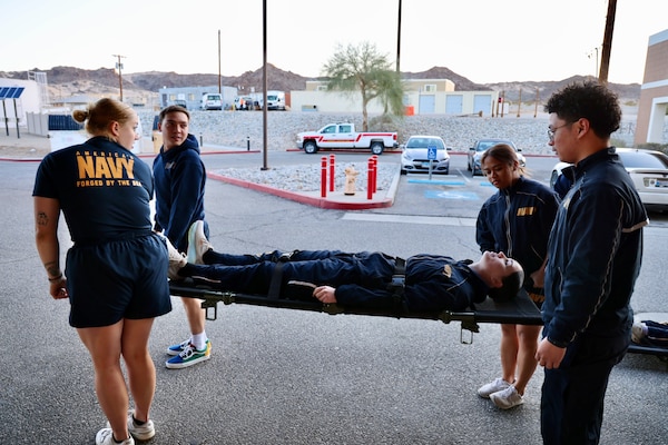 Hospital corpsmen assigned to the Multi-Service Unit at Naval Hospital Twentynine Palms participate in Tactical Combat Casualty Care (TCCC) training alongside the Marine Corps Air Ground Combat Center Fire Department on March 21. The hands-on exercise reinforced critical trauma response skills, ensuring corpsmen are prepared to provide life-saving care in mass casualty and combat scenarios (U.S. Navy photo by Christopher C. Jones, NHTP/NMRTC Twentynine Palms public affairs officer).