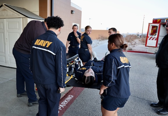 Hospital corpsmen assigned to the Multi-Service Unit at Naval Hospital Twentynine Palms participate in Tactical Combat Casualty Care (TCCC) training alongside the Marine Corps Air Ground Combat Center Fire Department on March 21. The hands-on exercise reinforced critical trauma response skills, ensuring corpsmen are prepared to provide life-saving care in mass casualty and combat scenarios (U.S. Navy photo by Christopher C. Jones, NHTP/NMRTC Twentynine Palms public affairs officer).
