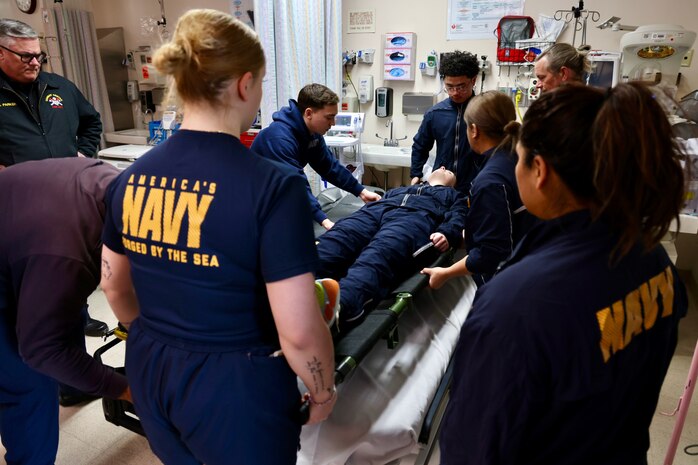 Hospital corpsmen assigned to the Multi-Service Unit at Naval Hospital Twentynine Palms participate in Tactical Combat Casualty Care (TCCC) training alongside the Marine Corps Air Ground Combat Center Fire Department on March 21. The hands-on exercise reinforced critical trauma response skills, ensuring corpsmen are prepared to provide life-saving care in mass casualty and combat scenarios (U.S. Navy photo by Christopher C. Jones, NHTP/NMRTC Twentynine Palms public affairs officer).